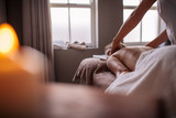 Woman having relaxing body massage in spa salon