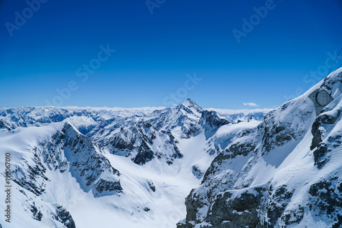 landscape big mountains snow covered blue sky background © jo1000du