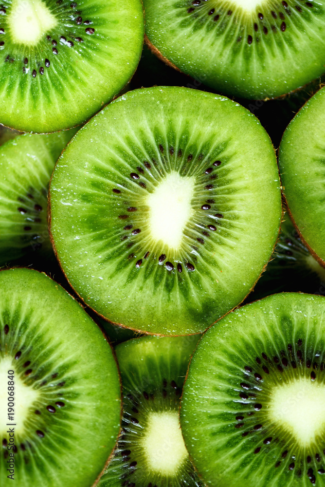 Fresh organic kiwi fruit sliced. Food frame with copy space for your text. Banner. Green kiwi circles background Fresh organic kiwi fruit sliced. Food frame with copy space for your text. Banner. Green kiwi circles background