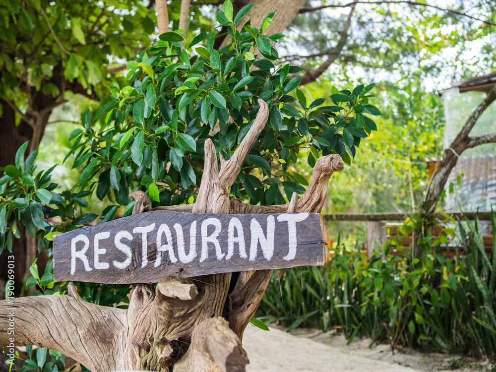 Fotografie Restaurant wooden banner on tree