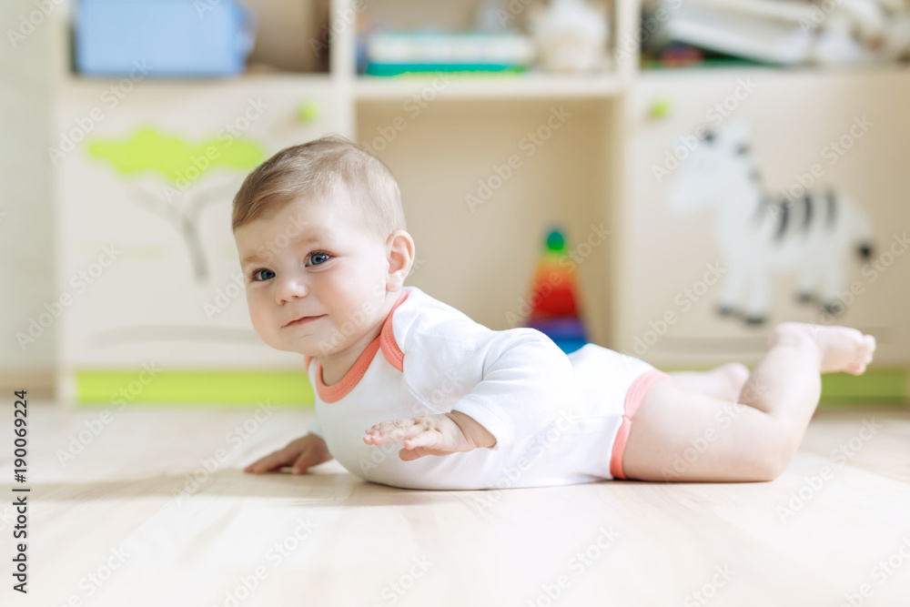Cute baby girl learning crawling and sitting in children room Cute baby girl learning crawling and sitting in children room
