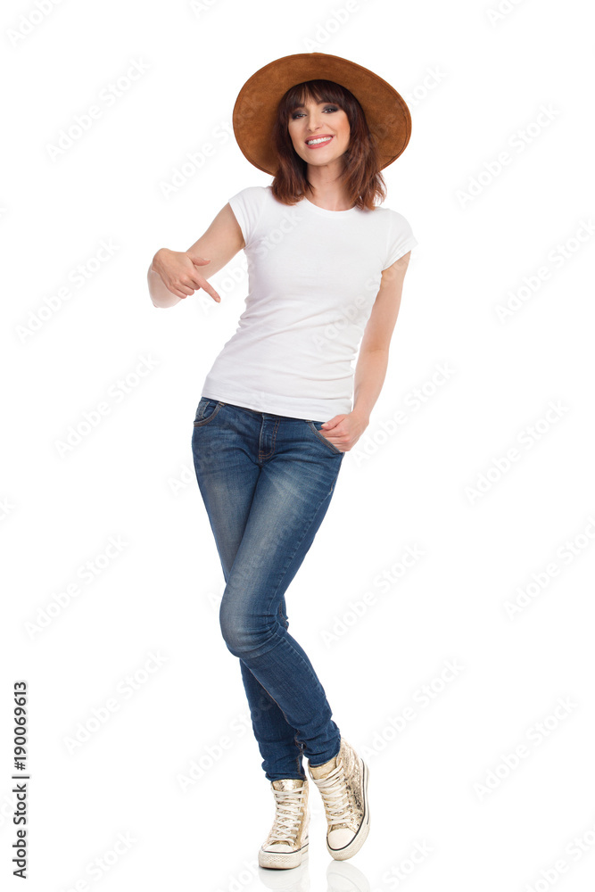 Beautiful Smiling Woman In Brown Hat Is Pointing At Her Waist Beautiful Smiling Woman In Brown Hat Is Pointing At Her Waist