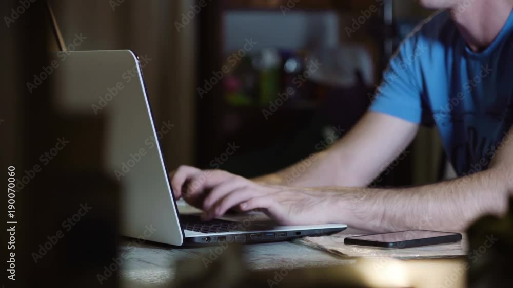 man working late on laptop man working late on laptop