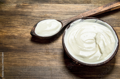 Natural yogurt in a bowl with a spoon.