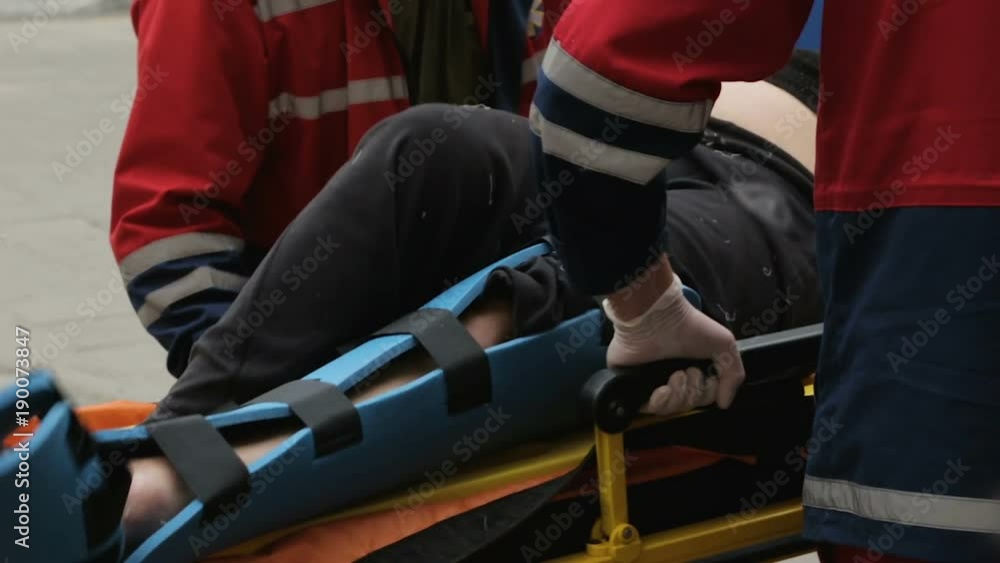 Medics taking injured person stretcher to X-ray room traumatology, leg problem Medics taking injured person stretcher to X-ray room traumatology, leg problem