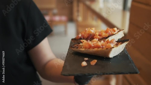 Chef is bringing out food to the customer. Delicious food being served.