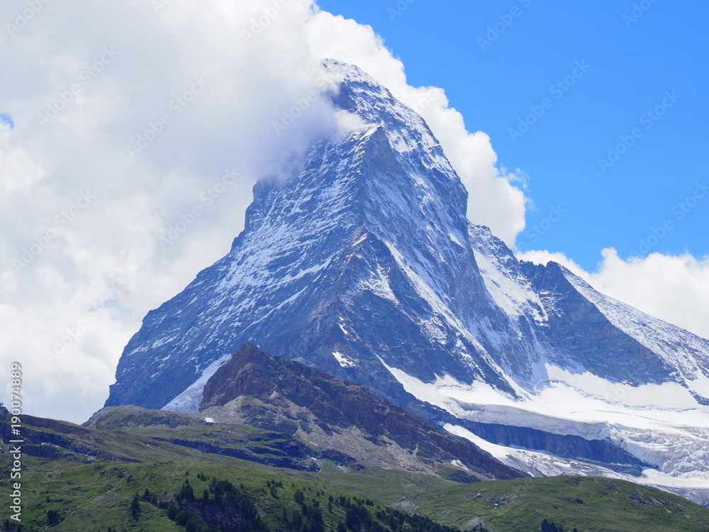 Matterhorn peak in clouds and alpine mountains range landscape in swiss Alps seen from Gornergrat in SWITZERLAND