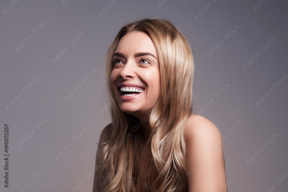 closeup portrait of beautyful blond laughing woman with clean fresh skin