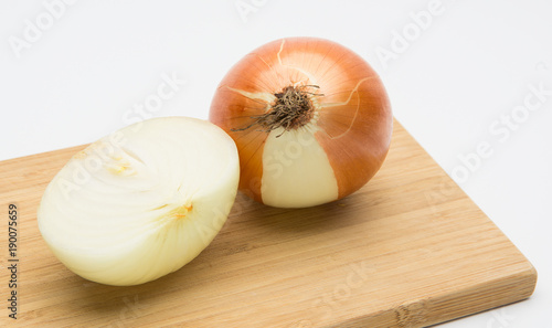 Cut fresh bulbs of onion on white background