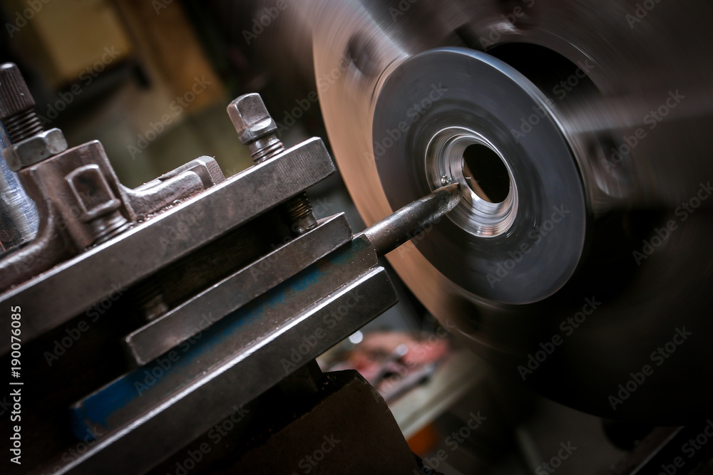 Metal worker working on lathe Metal worker working on lathe
