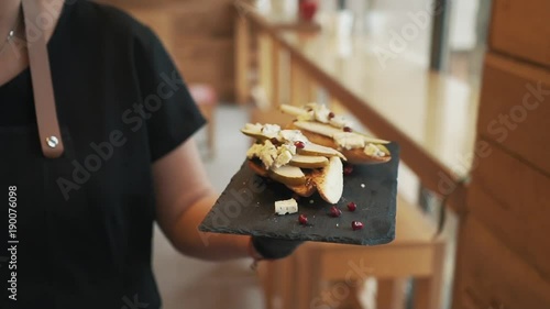 Chef is bringing out food to the customer. Delicious food being served.