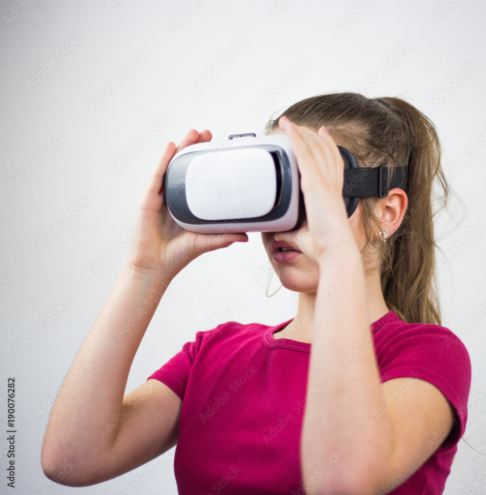 Teenager with virtual reality glasses on the head, enjoying watching, amazing technology, white background, studio Teenager with virtual reality glasses on the head, enjoying watching, amazing technology, white background, studio