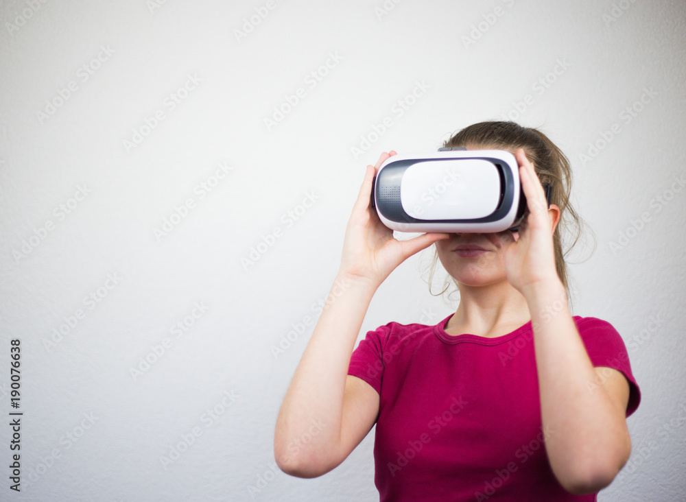 Teenager with virtual reality glasses on the head, enjoying watching, amazing technology, white background, studio Teenager with virtual reality glasses on the head, enjoying watching, amazing technology, white background, studio