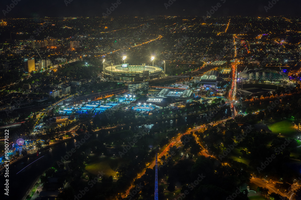 Melbourne Cricket Ground and Yarra Park tennis stadium illuminated at