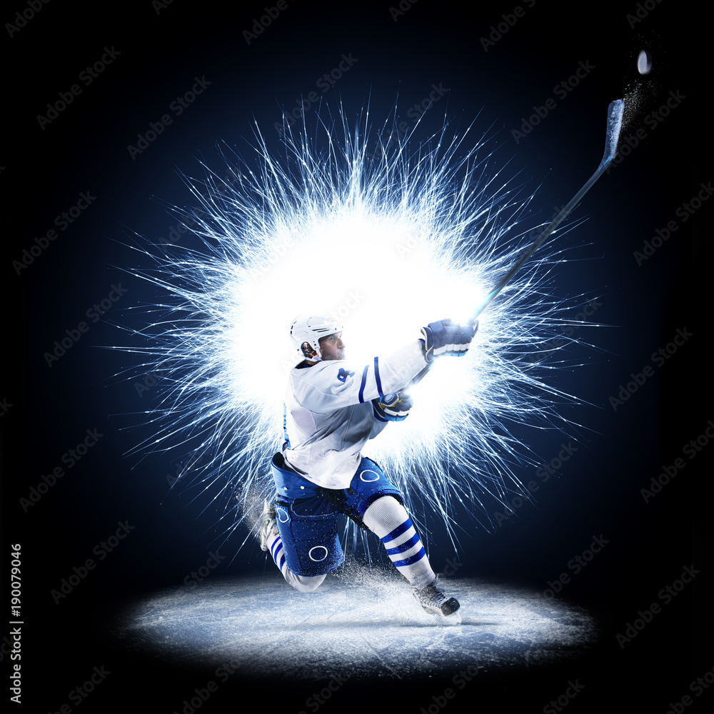 Fotografie Ice Hockey player is skating on a abstract background