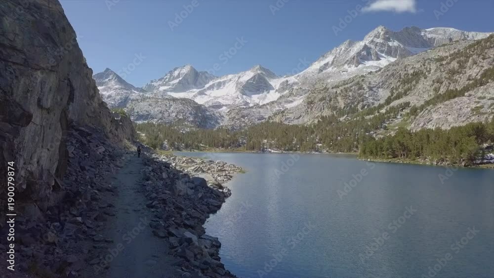 Aerial of hiker through Snow Mountain Valley with Lake reflection - Inyo National Forest, Little Lakes Valley Trail (Gem Lakes), Bishop, California Aerial of hiker through Snow Mountain Valley with Lake reflection - Inyo National Forest, Little Lakes Valley Trail (Gem Lakes), Bishop, California