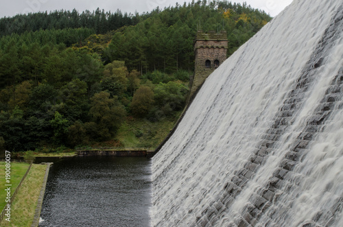 Water flowing over the top the the Derwent dam in the Peak District of England photo