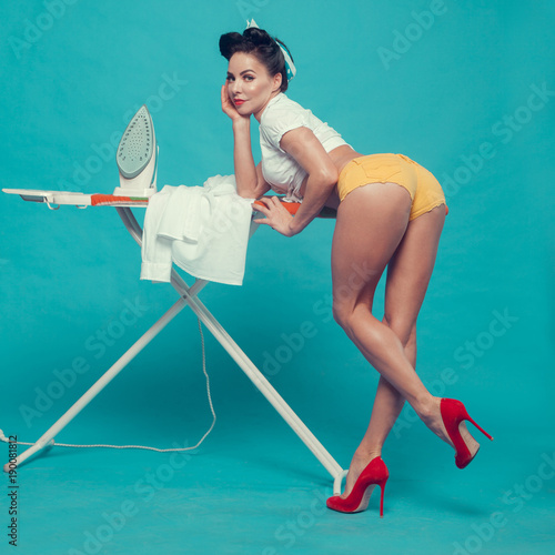 housewife in red shoes irons a shirt photo