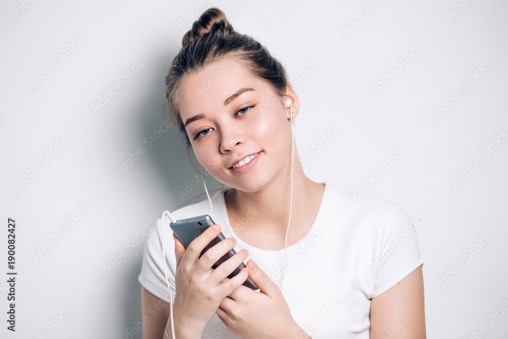 Happy young fit woman using cell phone while listening to music Happy young fit woman using cell phone while listening to music
