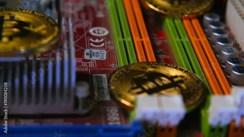 Gold bitkoyn on the background of the motherboard. Video close up. The concept of virtual money. photo