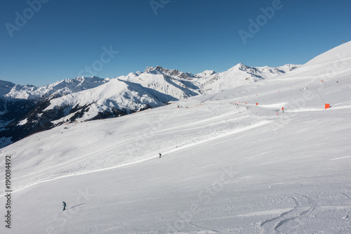 Schipiste mit Schifahrern in den tiroler Bergen