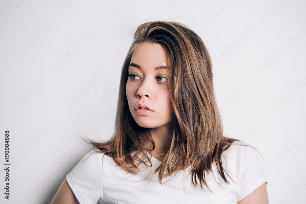 Portrait of beautiful girl posing on a white background,