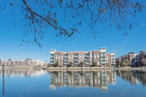 Riverside apartment building complex reflection blue sky