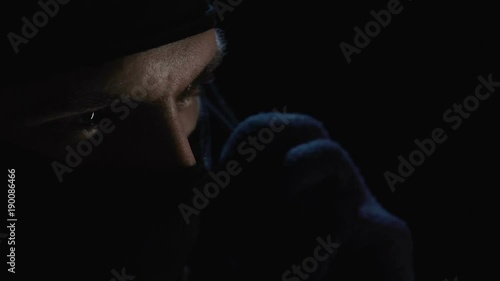 Criminal speaking on phone expressing his condition, demanding ransom for victim