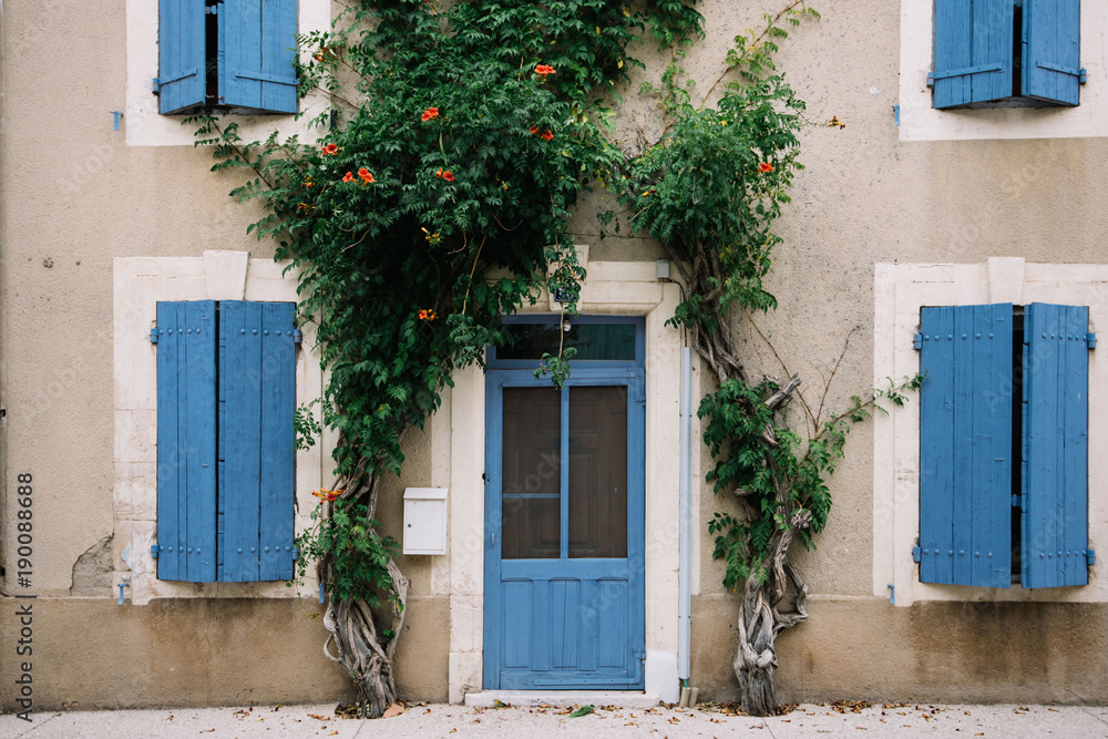 Old house with vivid blue door and shutters, Provence village, south France