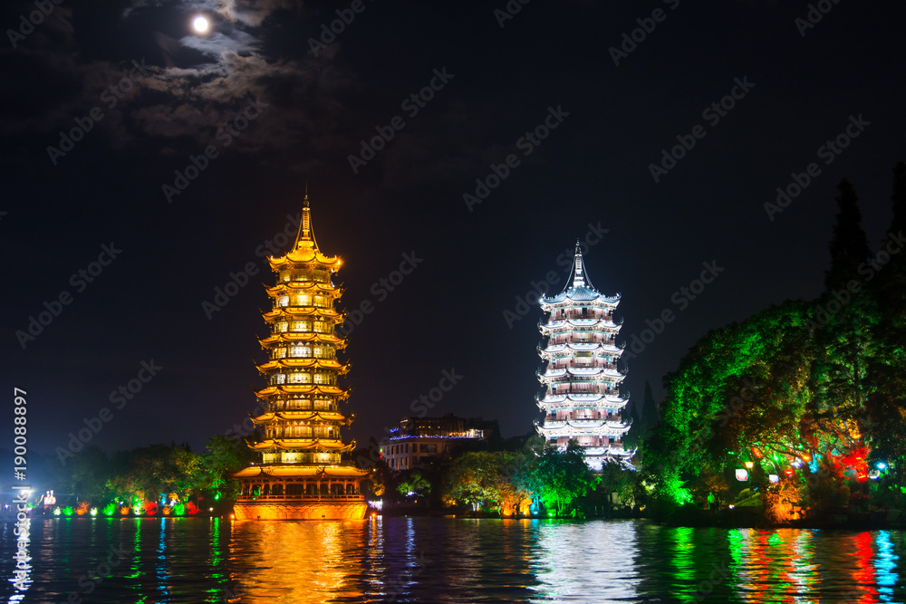 Two towers in Guilin in China with moonlight sky