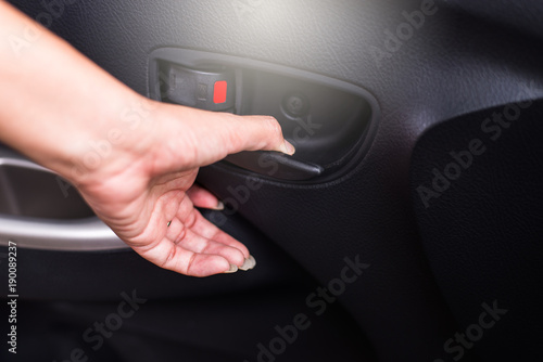 Hand using car open door lock inside sytem Safety door lock