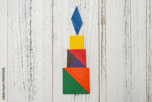 wooden tangram in a candle shape
