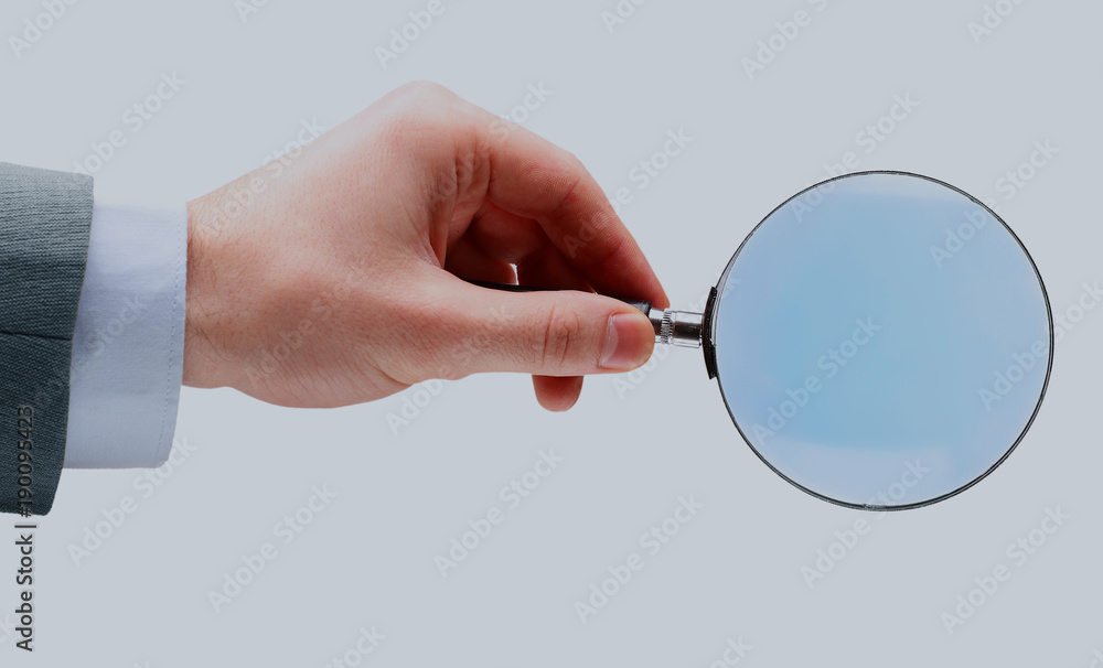 Magnifying glass in hand isolated over white background. Magnifying glass in hand isolated over white background.