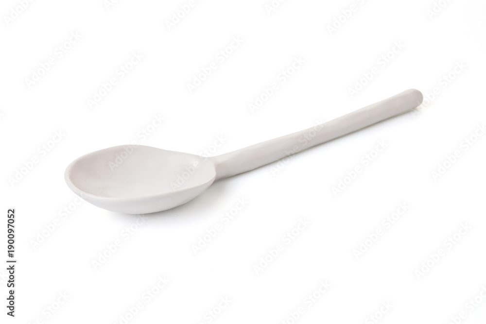 white ceramic spoon on white white ceramic spoon on white