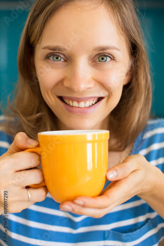 Happy Pretty Woman Enjoying Drinking Tea photo