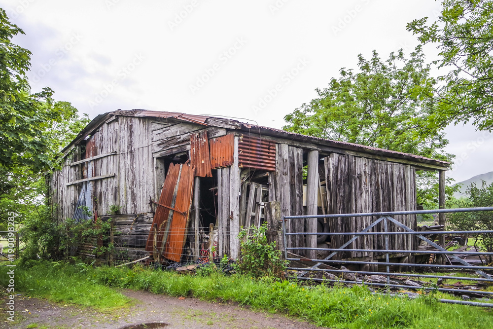 Old abandoned weathered wooden planked farmhouse rusty door Old abandoned weathered wooden planked farmhouse rusty door