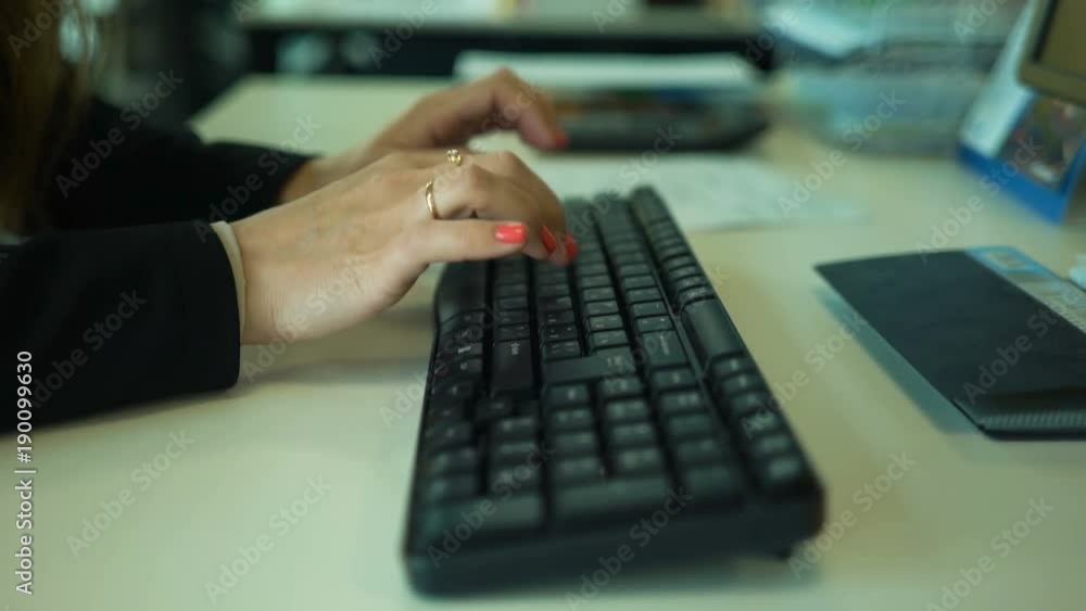 Female hands typing on computer keyboard Female hands typing on computer keyboard