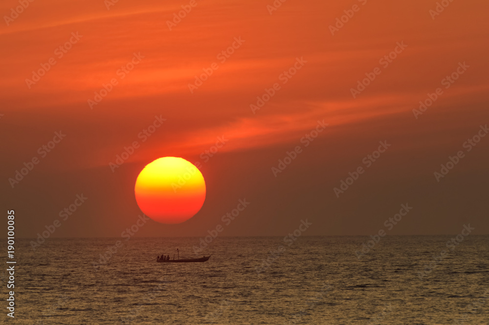Big sun over boat in sea on during sunset, Thailand