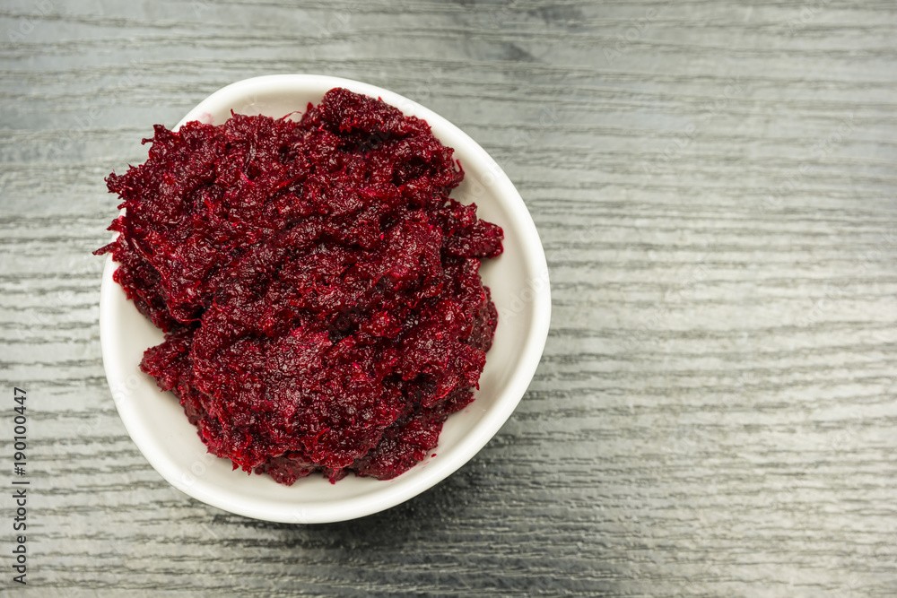 Grated beetroot with horseradish in a white bowl. View from above. Grated beetroot with horseradish in a white bowl. View from above.