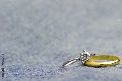 Fake diamond ring and gold ring placed on Jean jecket. The concept of love or marriage. Copy space can be used to write articles about Valentine's Day. photo