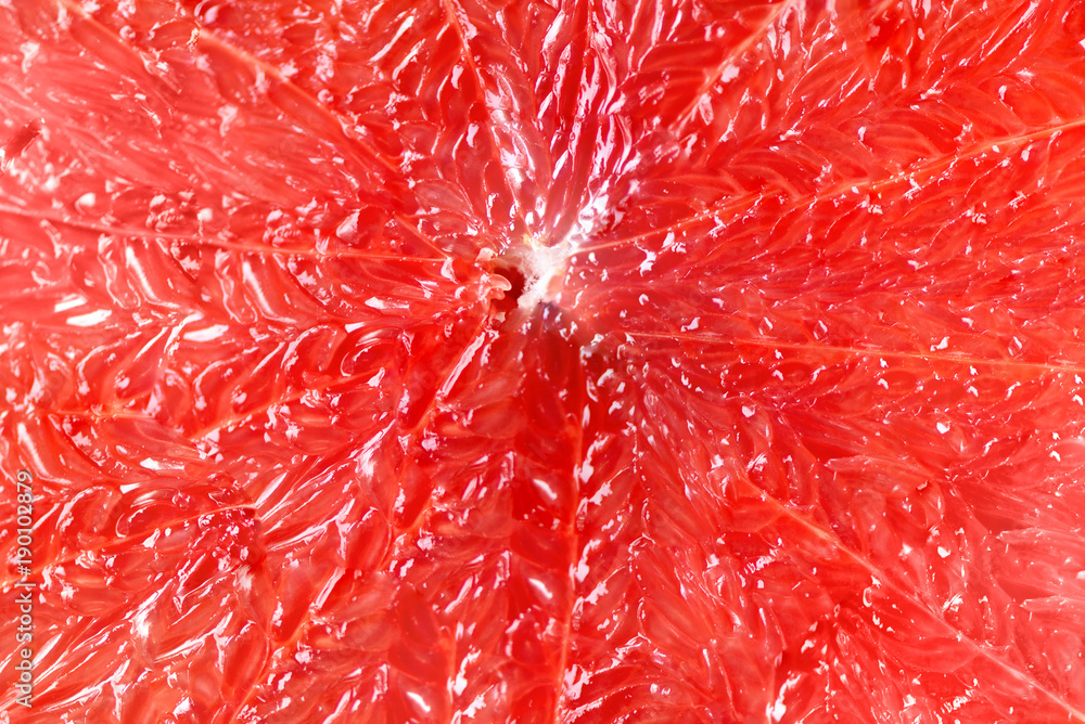 Grapefruit sliced half on grey background. Citrus fruit macro. Copy space, top view Grapefruit sliced half on grey background. Citrus fruit macro. Copy space, top view