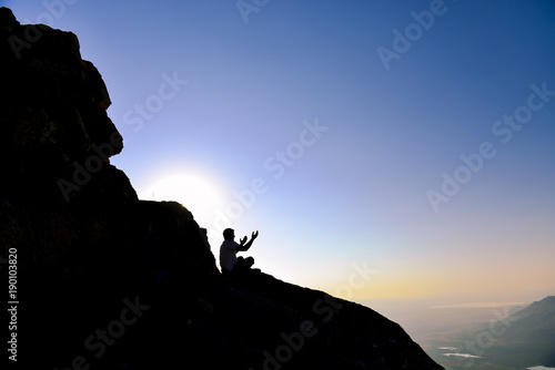 lonely man praying in the mountains