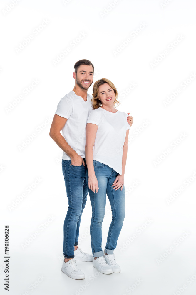couple in casual clothing hugging and looking at camera, isolated on white couple in casual clothing hugging and looking at camera, isolated on white