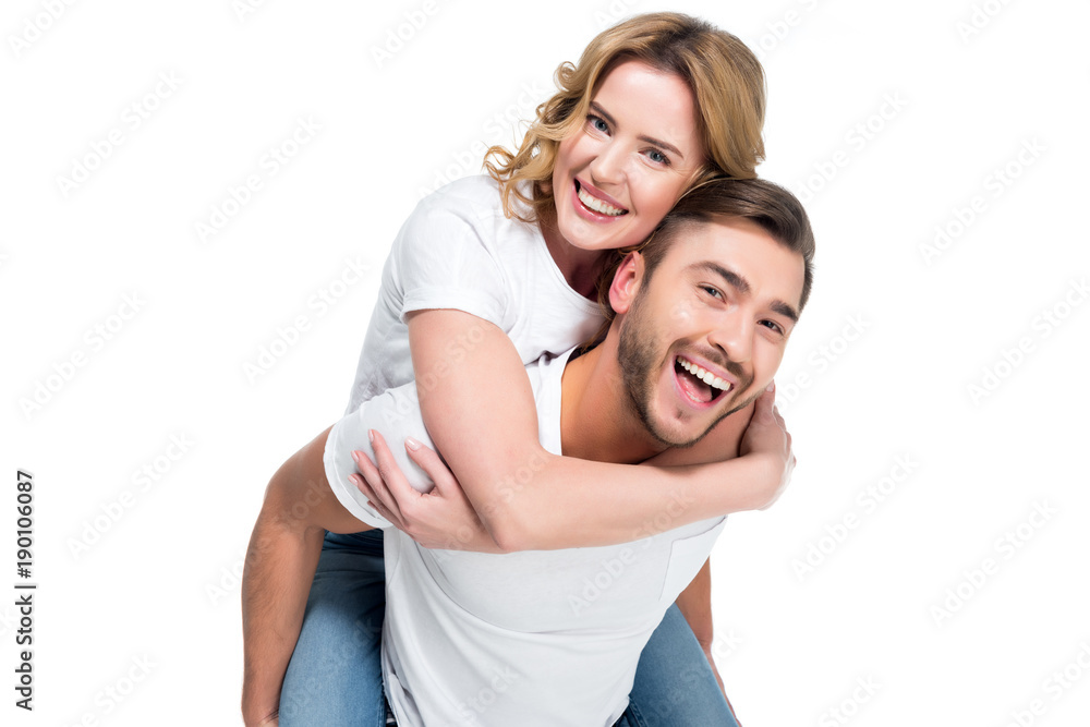 excited man piggybacking his smiling girlfriend, isolated on white excited man piggybacking his smiling girlfriend, isolated on white