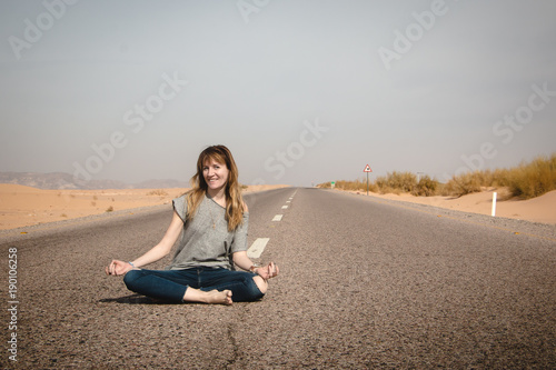 Girl have fun on the road in a desert