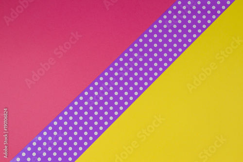 Abstract geometric yellow, purple and violet polka dot paper background.