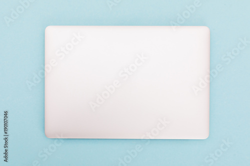 Top view of modern retina laptop, isolated on blue background. photo