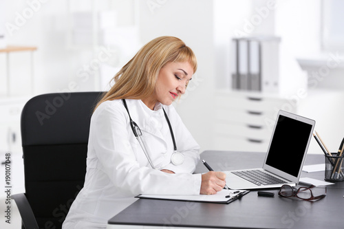 Female doctor filling up ap...
