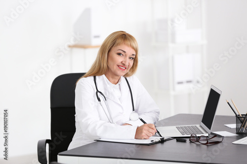 Female doctor filling up ap...