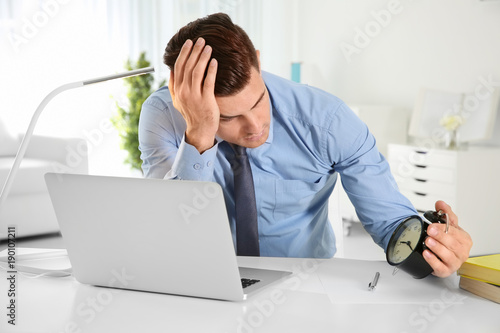 Troubled manager looking at...